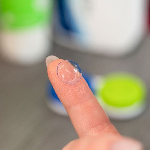 contact lens balanced on the tip of a finger